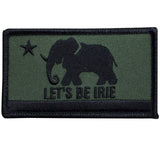A patch with a green background featuring a black silhouette of an elephant and the text 'LET'S BE IRIE'.