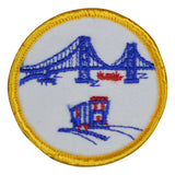A round embroidered patch featuring the Golden Gate Bridge and a San Francisco motif with a yellow border.