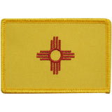 Yellow New Mexico patch with red emblem on a white background