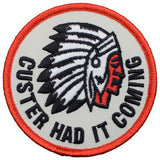 A round patch featuring an illustration of a Native American Indian headdress with the phrase 'Custer Had It Coming' around the outer edge.