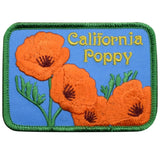 A rectangular patch featuring orange California poppies with green leaves on a blue background, and the text 'California Poppy' is embroidered at the top. The patch has a green border.