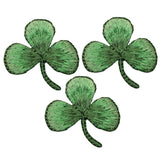 three green embroidered shamrock patches on a white background