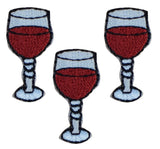 Three embroidered patches depicting glasses of red wine, with an iron-on backing.