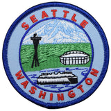 A round embroidered patch with 'Seattle Washington' text, depicting the Washington Ferry, Mount Rainier, and The Needle, with a football stadium, all surrounded by a blue border.
