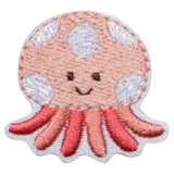 A small embroidered patch depicting a smiling jellyfish with pink tentacles and a white body with silver accents.