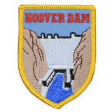 A shield-shaped patch featuring Hoover Dam with a 'Hoover Dam' text at the top. The patch has a yellow border and displays the dam amidst a stylized representation of a canyon.