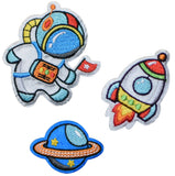 Set of three embroidered applique patches, featuring an astronaut, a rocket, and a planet, intended to be ironed on