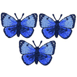 three blue butterfly patches on a white background
