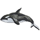 A embroidered whale applique patch, depicting a killer whale orca, with black, white, and gray colors on a white background.