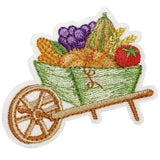 An embroidered patch showing a wheelbarrow filled with fruits and vegetables, indicative of a fall harvest.