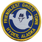 Round blue patch with a smiling ghost character, text 'FRIENDLIEST GHOST TOWN HYDER, ALASKA', and a yellow embroidered border.