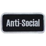 A rectangular black patch with the words 'Anti-Social' in white text, bordered with a white thread.