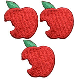 Three embroidered patches shaped like red apples with a bite mark and a green leaf on top.