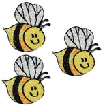 Three embroidered patches depicting smiling honey bees with a black, white, and yellow color scheme, designed to be ironed onto fabric.
