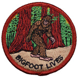 A patch featuring an illustration of Bigfoot standing in a forest with the text 'BIGFOOT LIVES' 