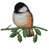 Embroidered patch depicting a chickadee bird perched on a branch with leaves.