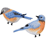 Two embroidered patches depicting blue birds with iron-on backing, designed for application on fabric.