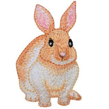 Embroidered patch of a brown and white bunny rabbit with pink ears.