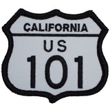 A shield-shaped patch with the text 'CALIFORNIA US 101' on it, predominantly white with a black border and black lettering.