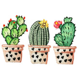 Three embroidered cactus plants in heart pots on a white background