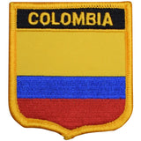 A shield-shaped patch featuring horizontal stripes of yellow, blue, and red with the word 'COLOMBIA' written across the top in bold letters.