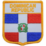 A shield-shaped embroidered patch with the flag colors of the Dominican Republic and the national emblem in the center, with a label reading 'DOMINICAN REPUBLIC' at the top.