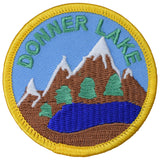 A round embroidered patch featuring the text 'Donner Lake' with an illustration of mountains and a lake, designed for iron on application.