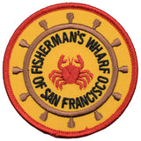 A round patch with a red crab in the center, surrounded by text 'FISHERMAN'S WHARF SAN FRANCISCO'. The patch has a yellow background with a red border.