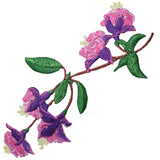 Embroidered patch of pink and purple fuchsia flowers on a brown stem with green leaves, isolated on a white background.