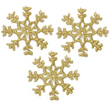 Three gold mini snowflake applique patches with a metallic finish designed for iron on application