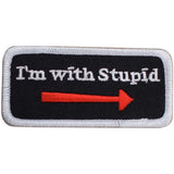 A rectangular novelty badge patch with the phrase 'I'm with Stupid' written in white text on a black background, accompanied by a red arrow pointing to the right.