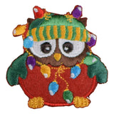 An embroidered patch depicting an owl wearing a Christmas-themed hat with a string of lights.