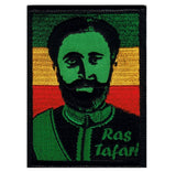 A patch with a portrait of Haile Selassie I, featuring green, yellow, and red colors, with the text 'Ras Tafari'.