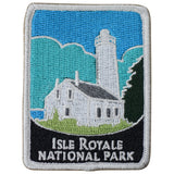 A rectangular embroidered patch featuring the Rock Harbor Lighthouse with the text 'Isle Royale National Park' beneath it.