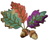 A colorful embroidered patch depicting autumn leaves and acorns with an iron-on application backing.
