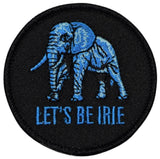 Circular, black embroidered patch featuring a blue silhouette of an elephant above the blue text, 'LET'S BE IRIE'.