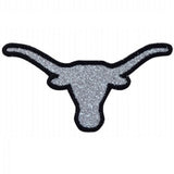 A patch in the shape of a longhorn steer head with a sparkly, silver-colored body and black outline.