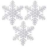three white snowflake appliques with fine detailed embroidery
