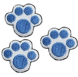 Three blue and white mini puppy paw print applique patches designed to be iron on.