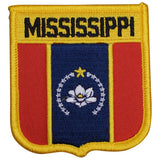 A shield-shaped embroidered patch with vertical stripes in red and blue, featuring a white flower emblem and the text 'Mississippi'.