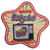 A colorful embroidered patch with the text 'MOVIE NIGHT' and an image of a cinema projector, designed to be ironed onto fabric.