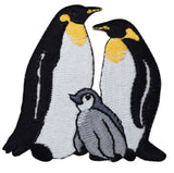 An embroidered patch featuring two king penguins and a baby chick.