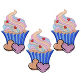Three embroidered patches depicting cupcakes with frosting, sprinkles, and heart-shaped candies, each with a pair of hearts underneath.