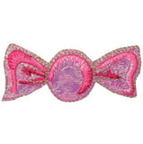 A pink candy-shaped applique patch with a shimmery finish designed to be ironed onto fabric.