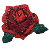 A red rose applique patch with green leaves, designed to be ironed onto fabric.