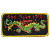 A patch featuring a red and green embroidered Chinese dragon with the text 'SAN FRANCISCO' on a black background with a yellow border.
