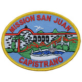 Embroidered patch depicting Mission San Juan Capistrano with an iron-on backing, featuring red, blue, green, and yellow colors.