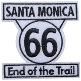 Embroidered patch with the text 'Santa Monica 66 End of the Trail' and the number 66 in a circular design, a sign found on Route 66 in California.