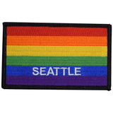 A rectangular, embroidered patch featuring the Seattle rainbow colors with the word 'SEATTLE' in white letters on a blue background.