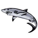 a gray, black, and white shark patch on a white background